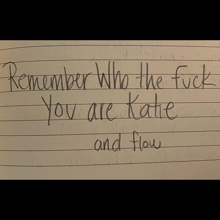 A handwritten note on lined paper reading Remember Who the Fuck You are Katie, and flow.